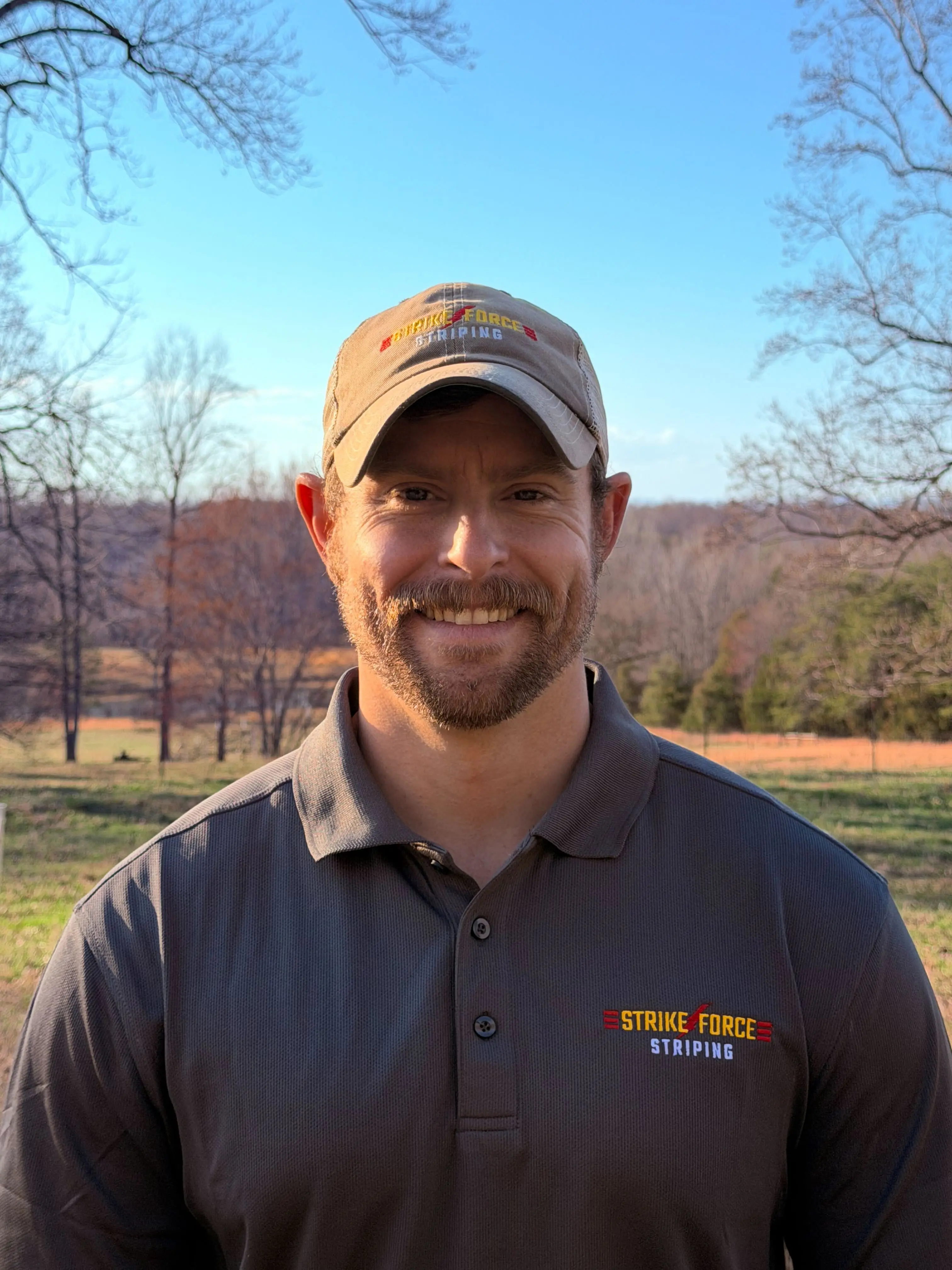 John Wood, Founder of Strike Force Striping, wearing branded polo and cap